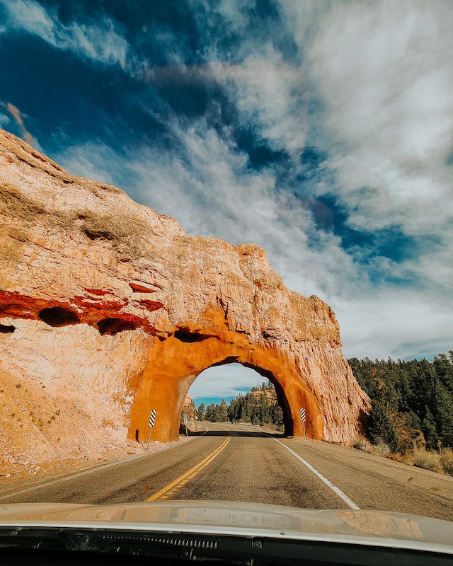 Road through sandstone arch in Utah