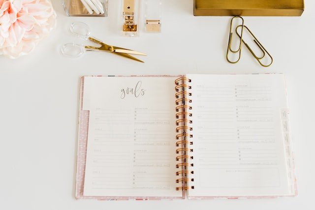 Planner showing goal page laying open on a desk