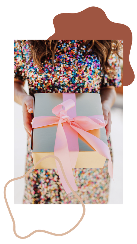 Woman holding present wrapped in pink bow