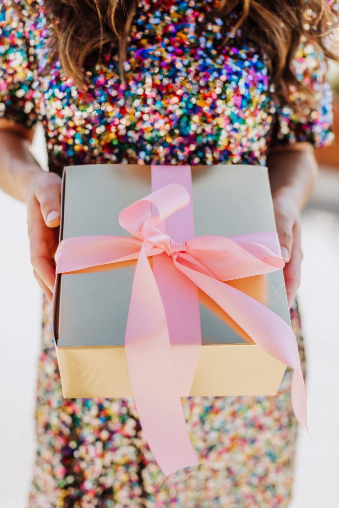 Close up of gold box wrapped in pink bow