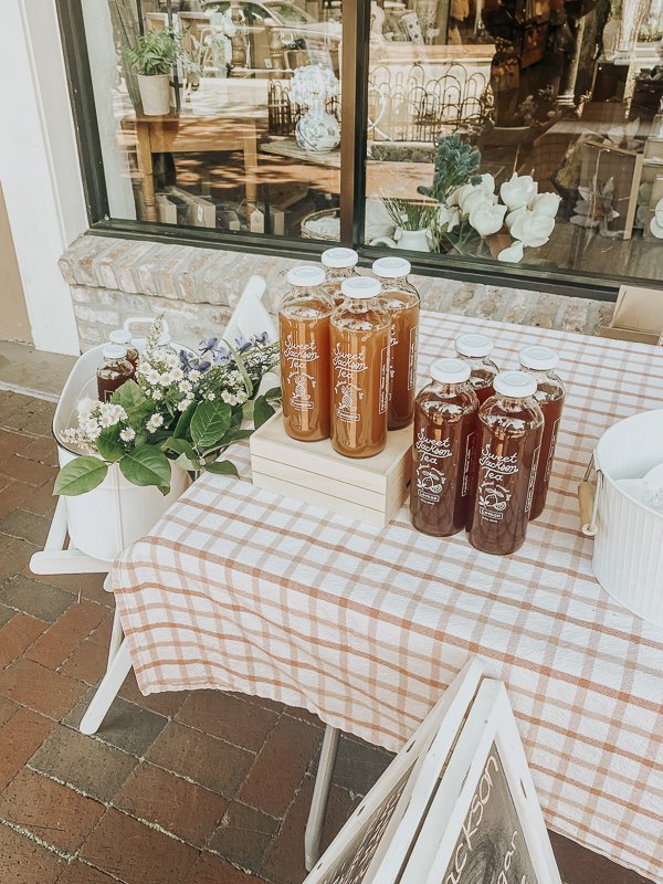 Glass bottled sweet tea sitting on a white and red checkered table cloth | Sweet Jackson Tea in Pensacola