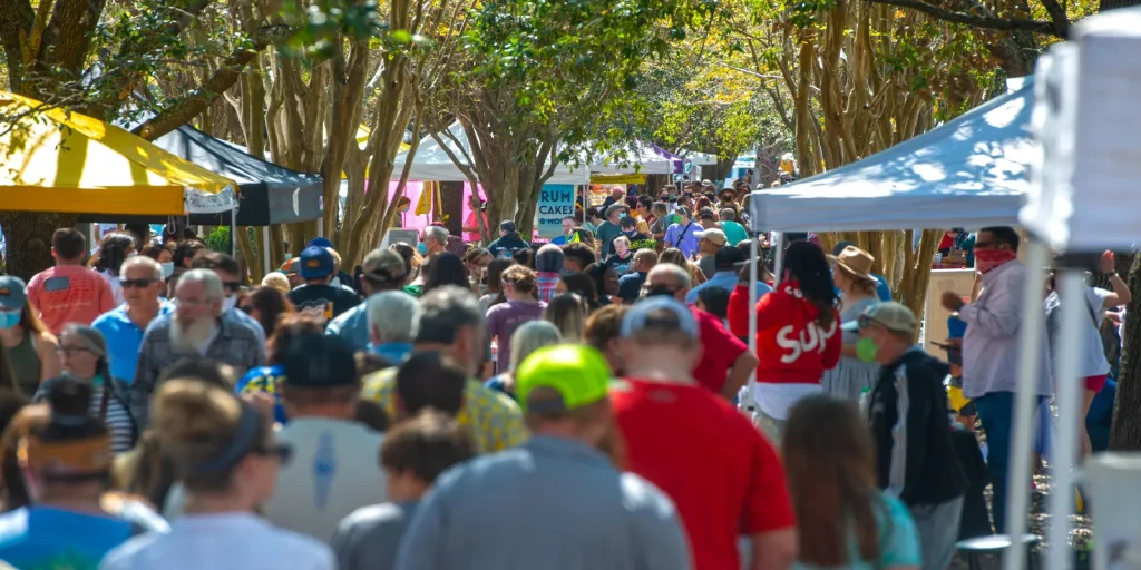 Crowd of visitors walking through Palafox Market in downtown Pensacola