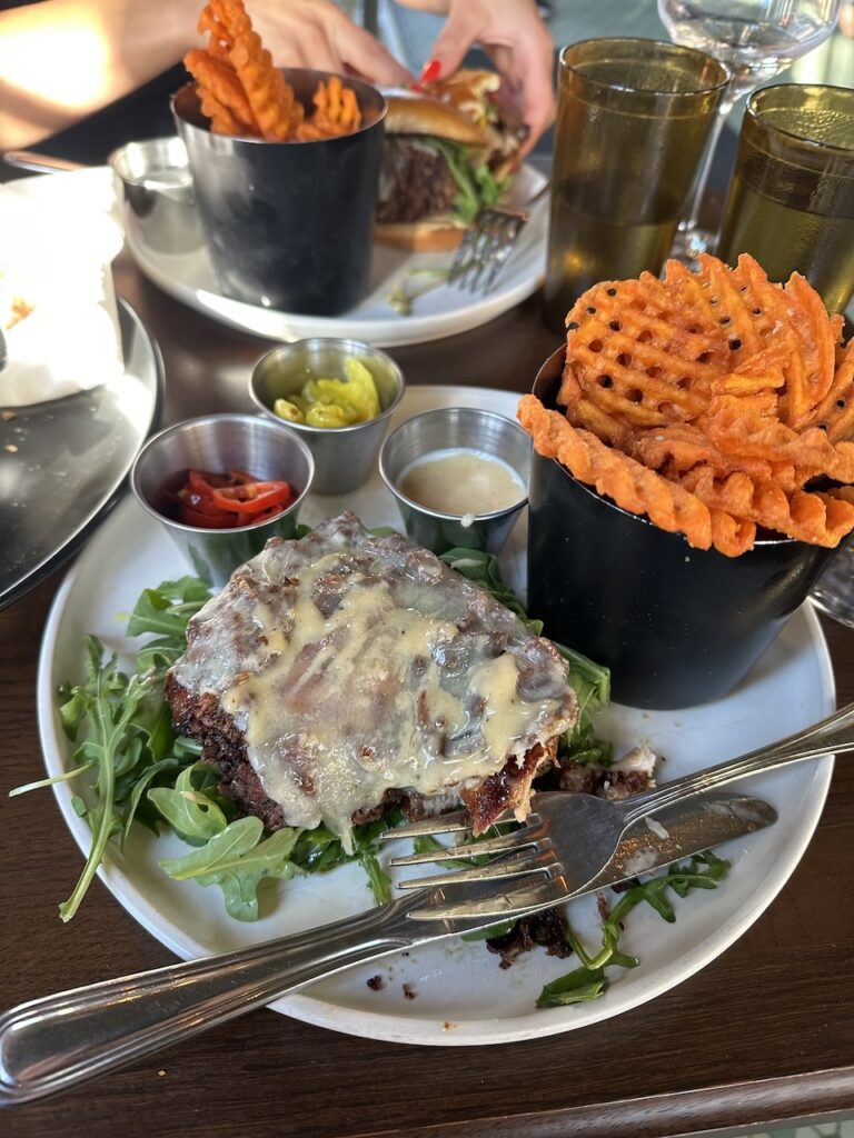 Plate of Hot Honey Fried Chicken Sandwich and Sweet Potato Waffle Fries at The Burrow in East Hill Pensacola